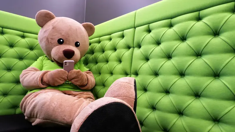 Der WHG Bär sitzt auf dem Sofa
